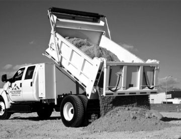black and white image of a dump truck unloading